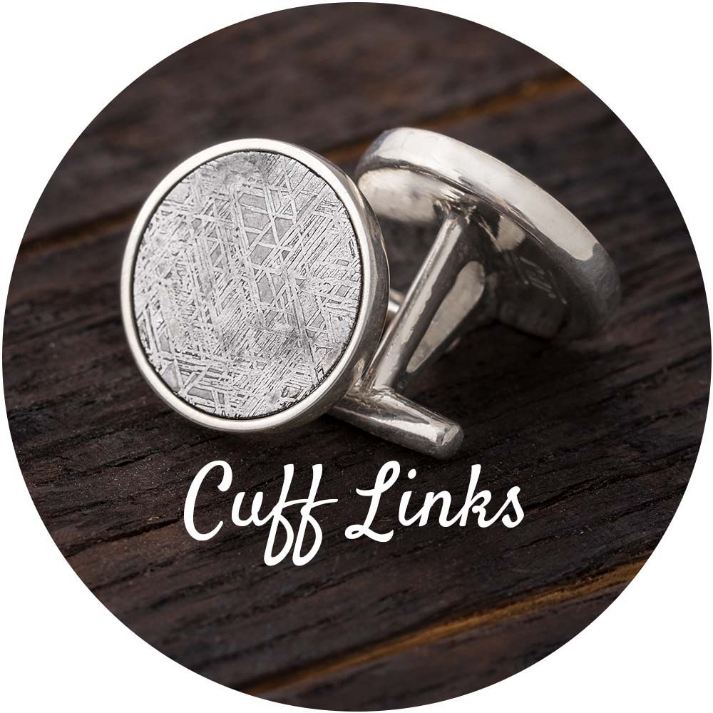 Cuff links displayed on a wooden surface in a circular frame.