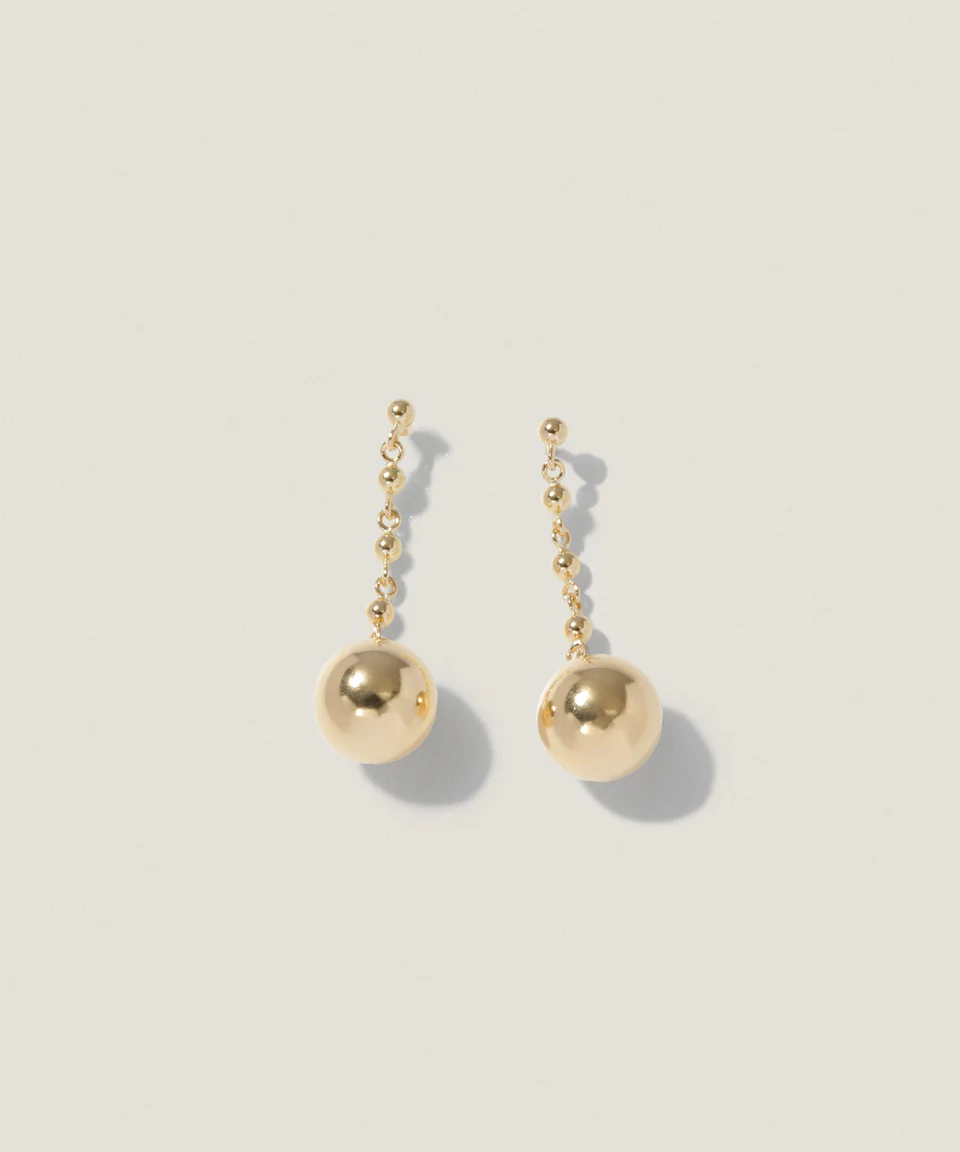 Gold drop earrings with spherical pendants and small bead accents.