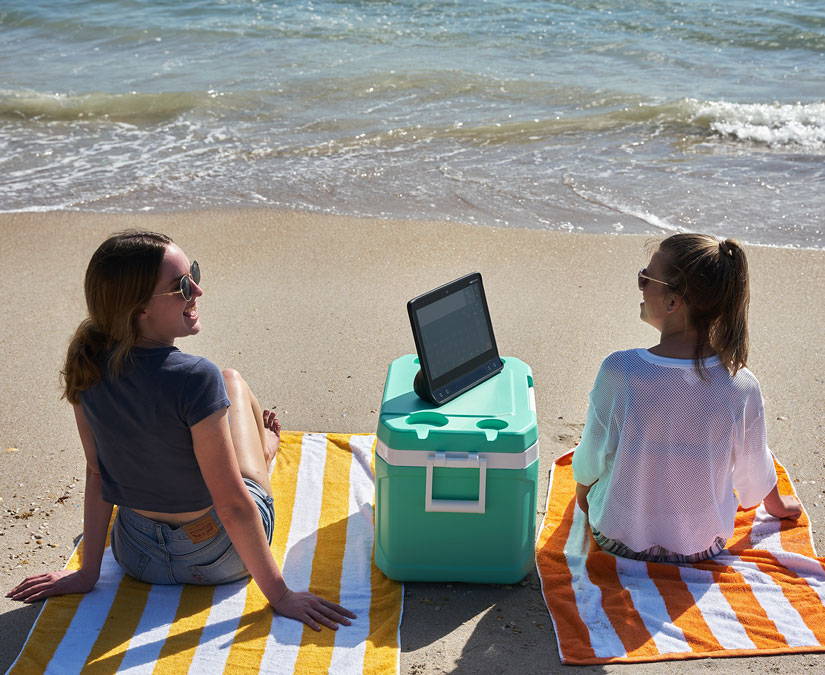 Woman using her Tobii Dynavox I-16 device at the beach