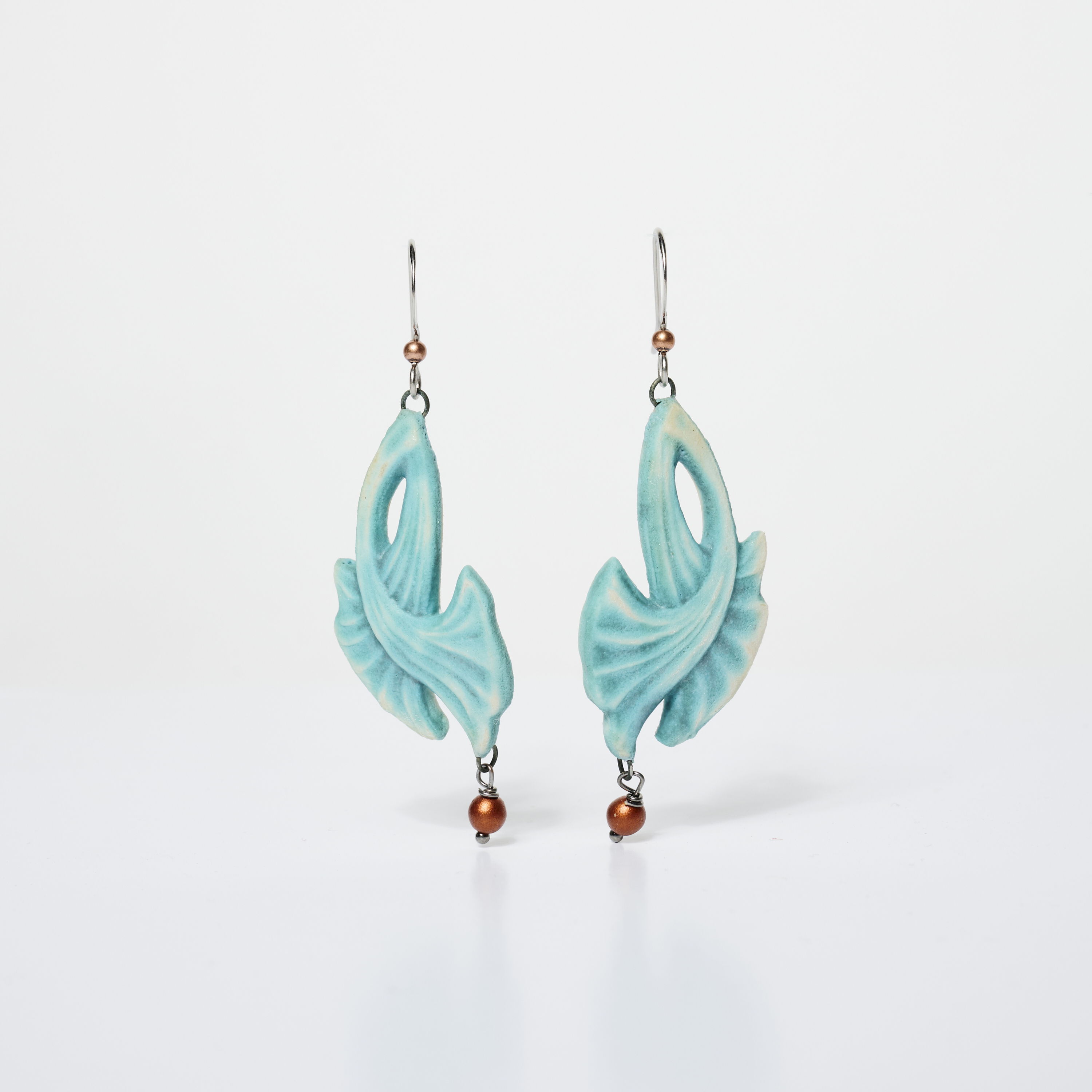 Turquoise earrings with a leaf design and copper accents.