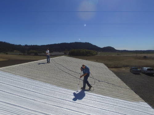 Maximum Stretch being sprayed on to a metal roof