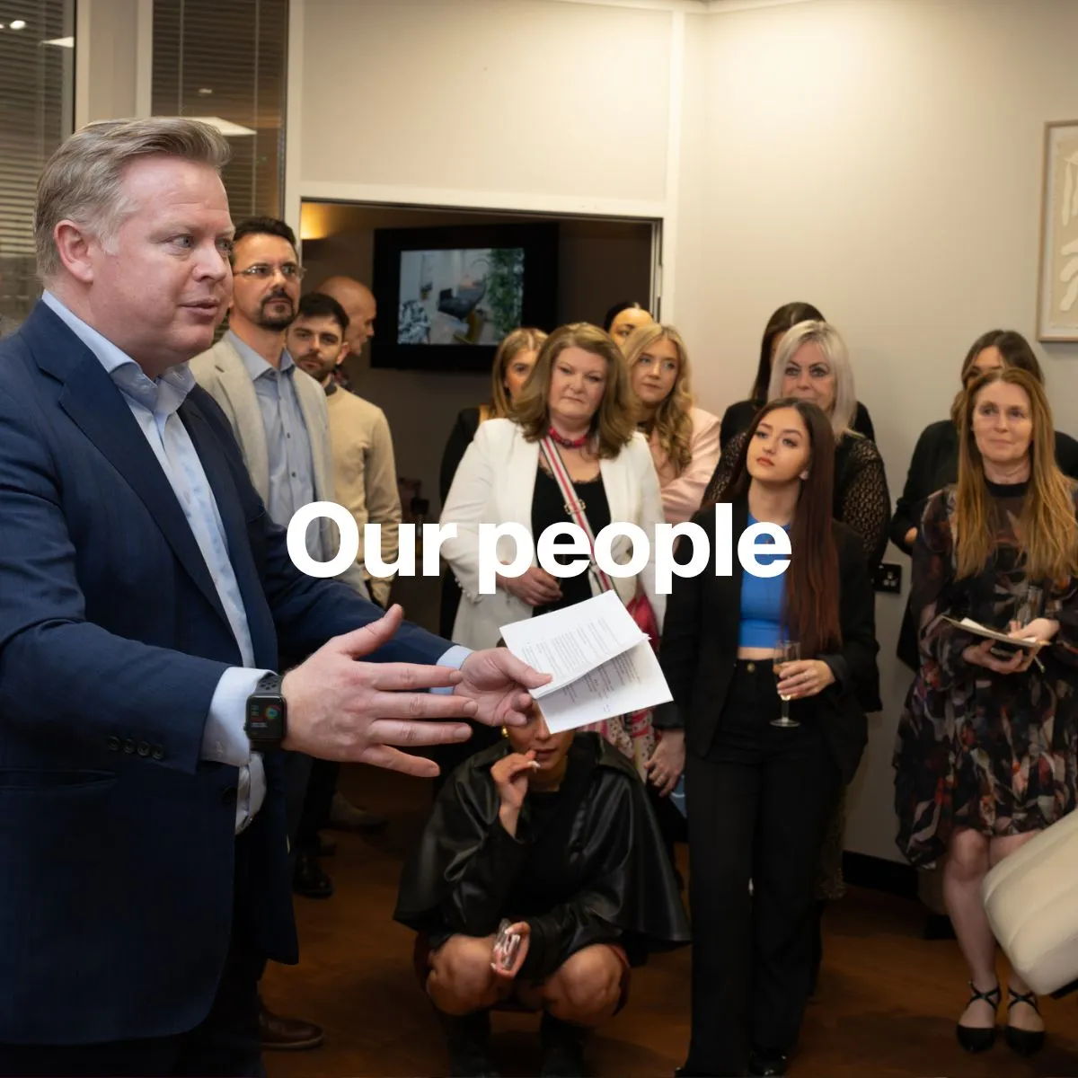 Ellisons Chairman speaking to a group of people in an indoor setting.
