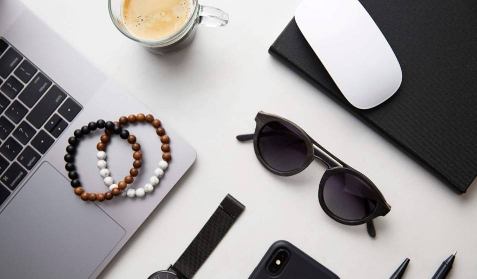 flatlay with beaded bracelets, sunglasses, watch and men's accessories