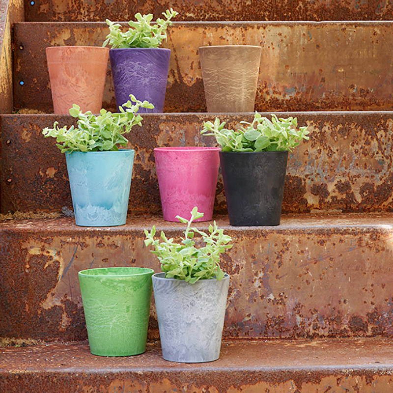 Every cache pot planter color option displayed on outdoor steps