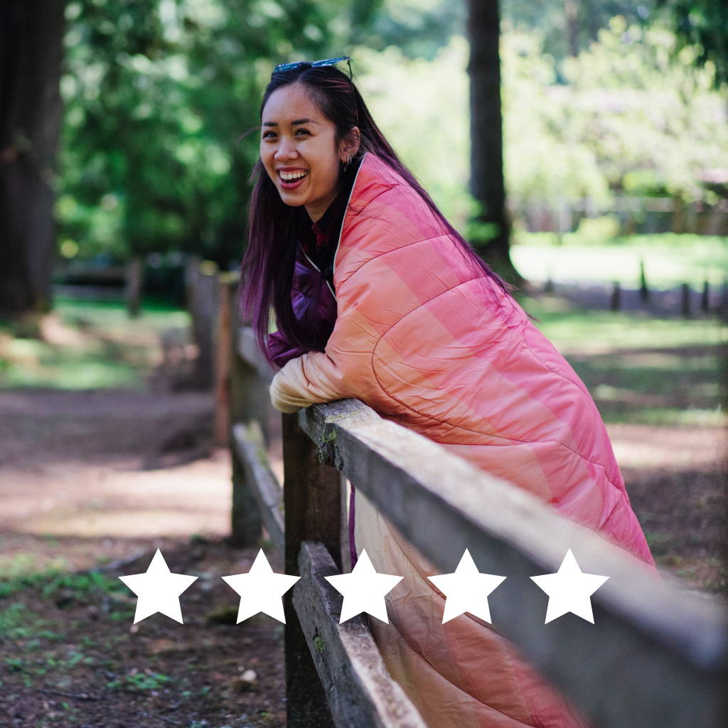 Woman wrapped in pink blanket outside