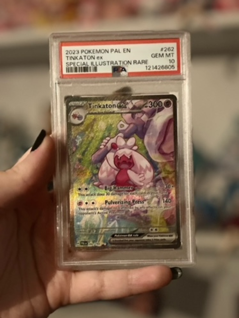 A PSA 10 Gem Mint graded Tinkaton ex Special Illustration Rare Pokémon card from the Paldea Evolved expansion, Jess's favorite card.