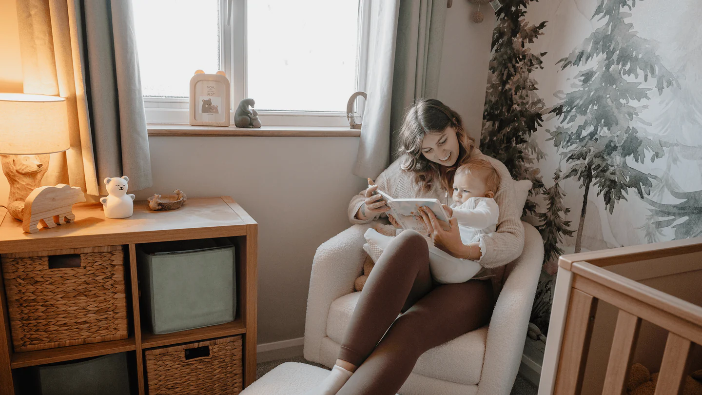 Mother breastfeeding her baby in a cozy, well-lit room.