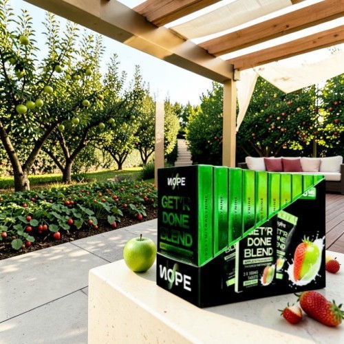 Box of juice blends on a table with apple trees in the background.