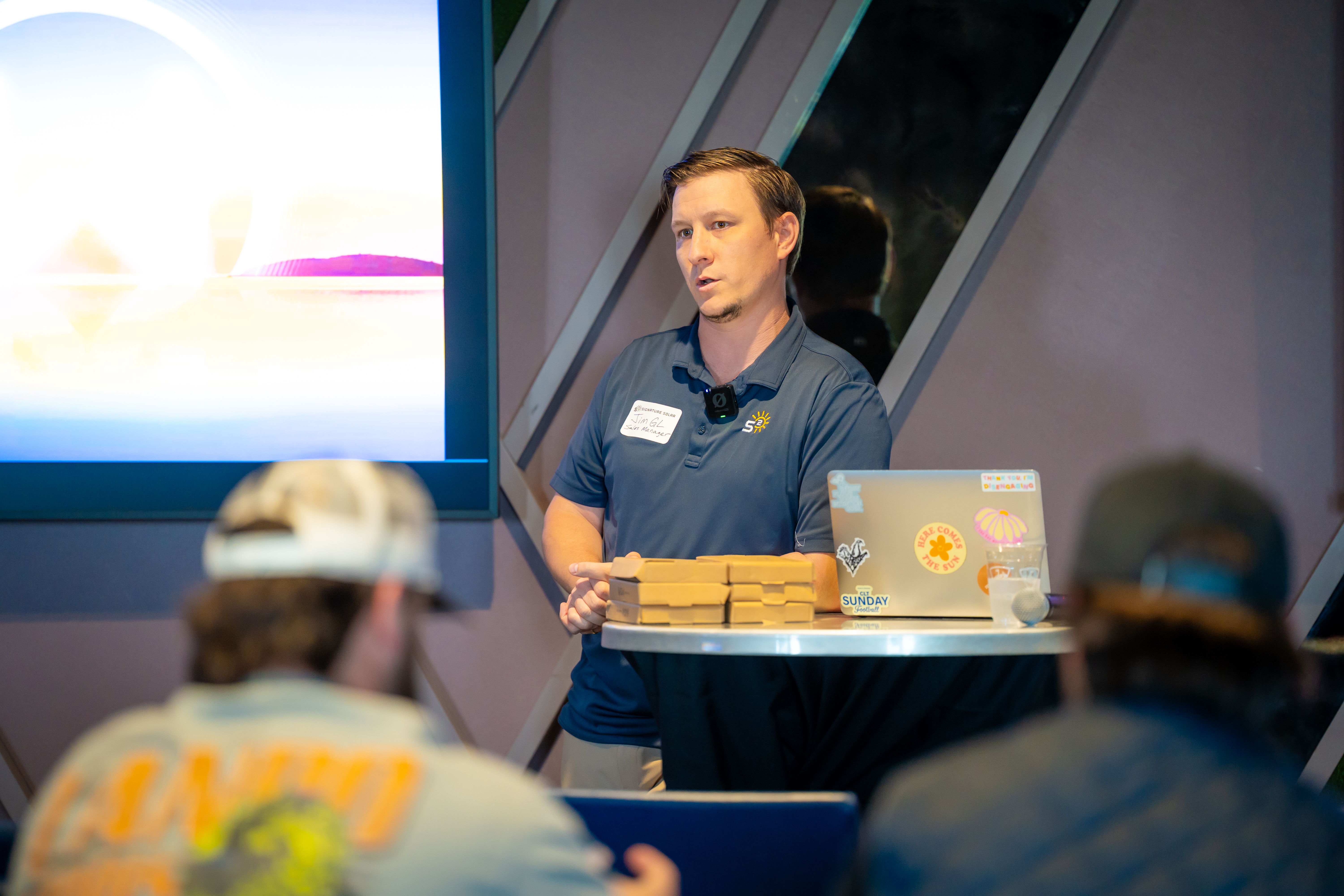 Person giving a presentation at a conference with audience in view.