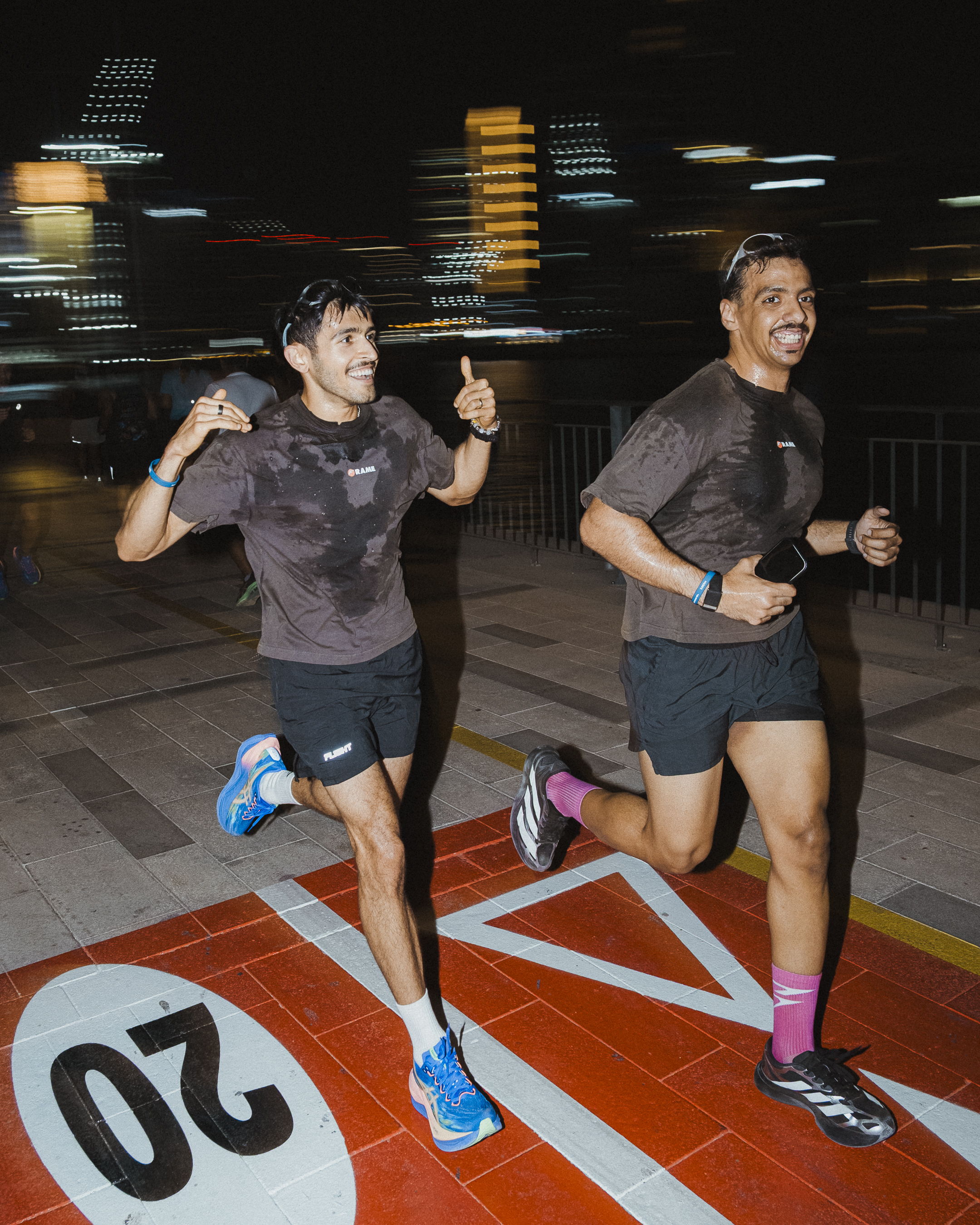 Runners enjoying a community run along the Dubai Canal during Global Running Day with ASICS and FRAME RUN CLUB in Dubai Design District.