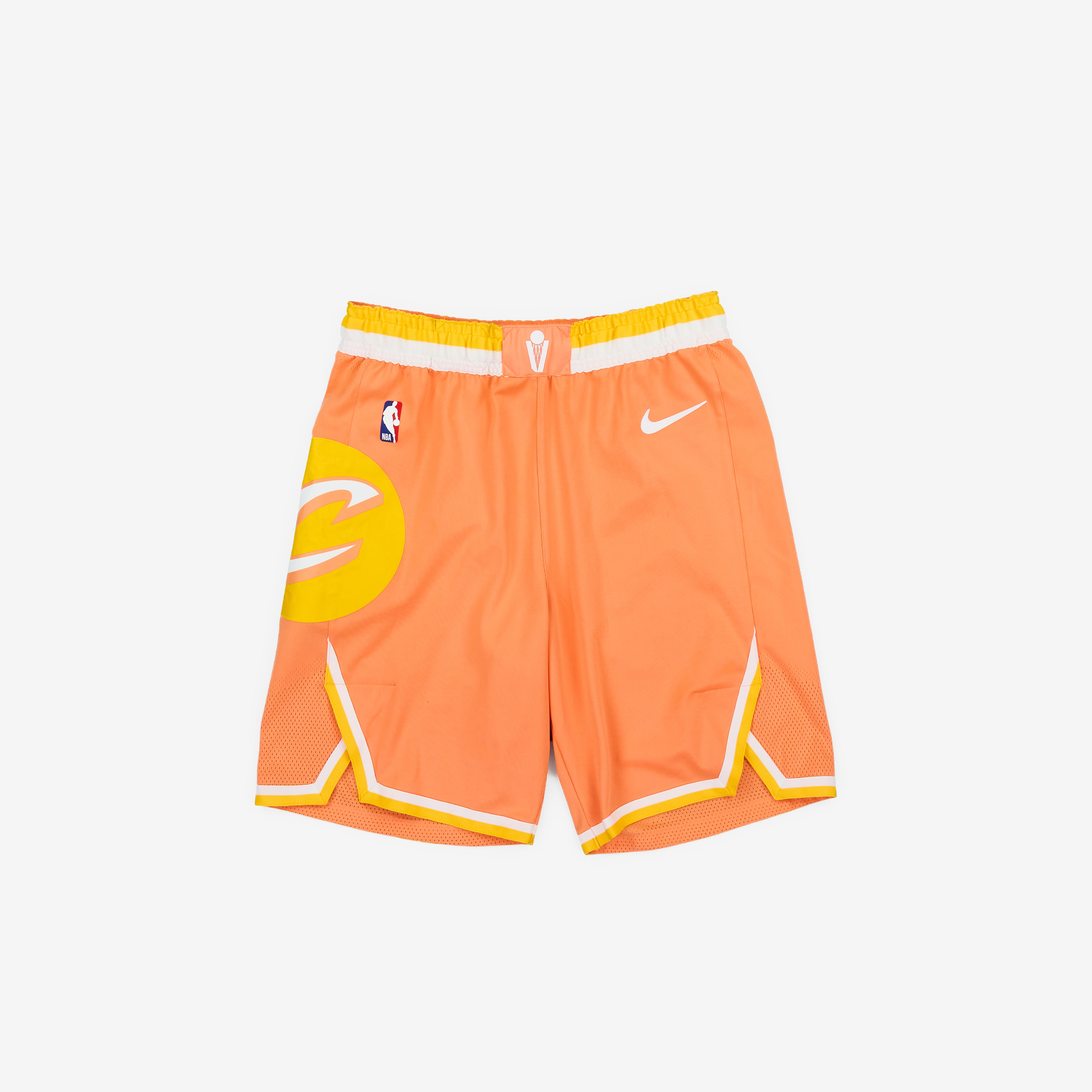 Orange Nike basketball shorts with yellow accents and logo.