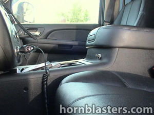 Interior train horn activation button mounted beside center console