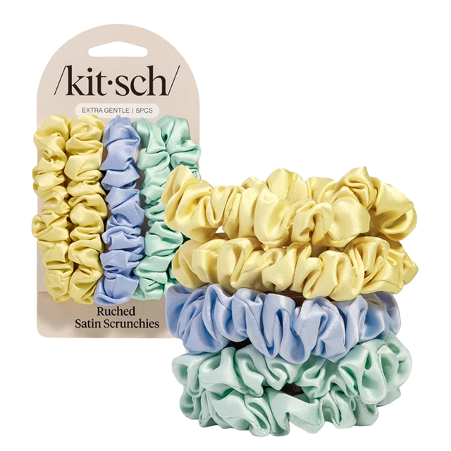 Four satin scrunchies in pastel colors with packaging.
