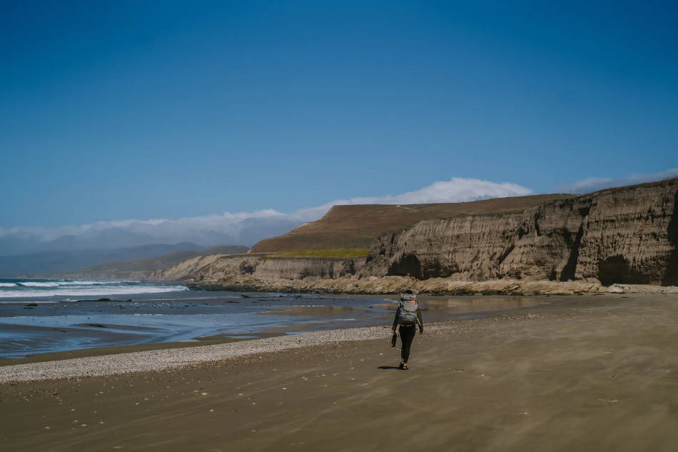 woman on an adventure on a beach wearing hiking sandals