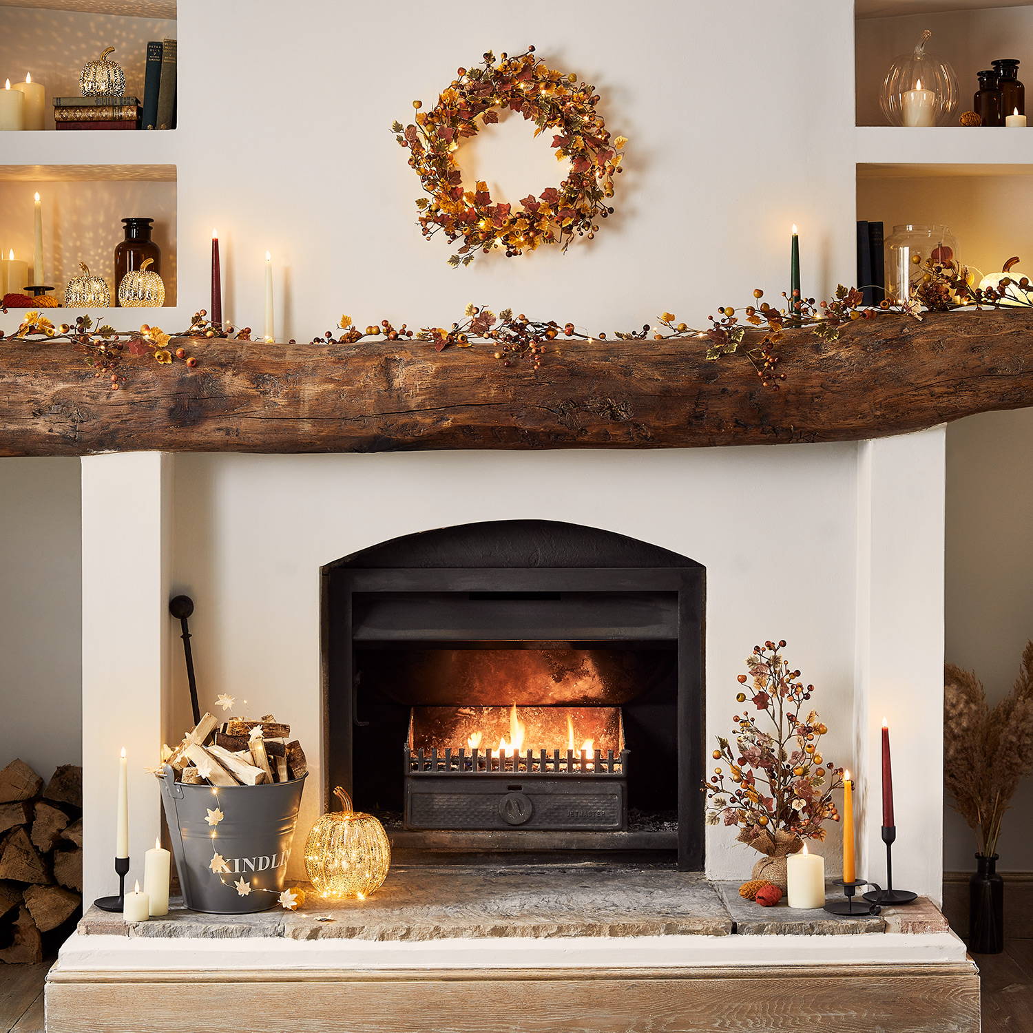 Fireplace and mantelpiece decorated for autumn with wreath and garland and autumn decorations