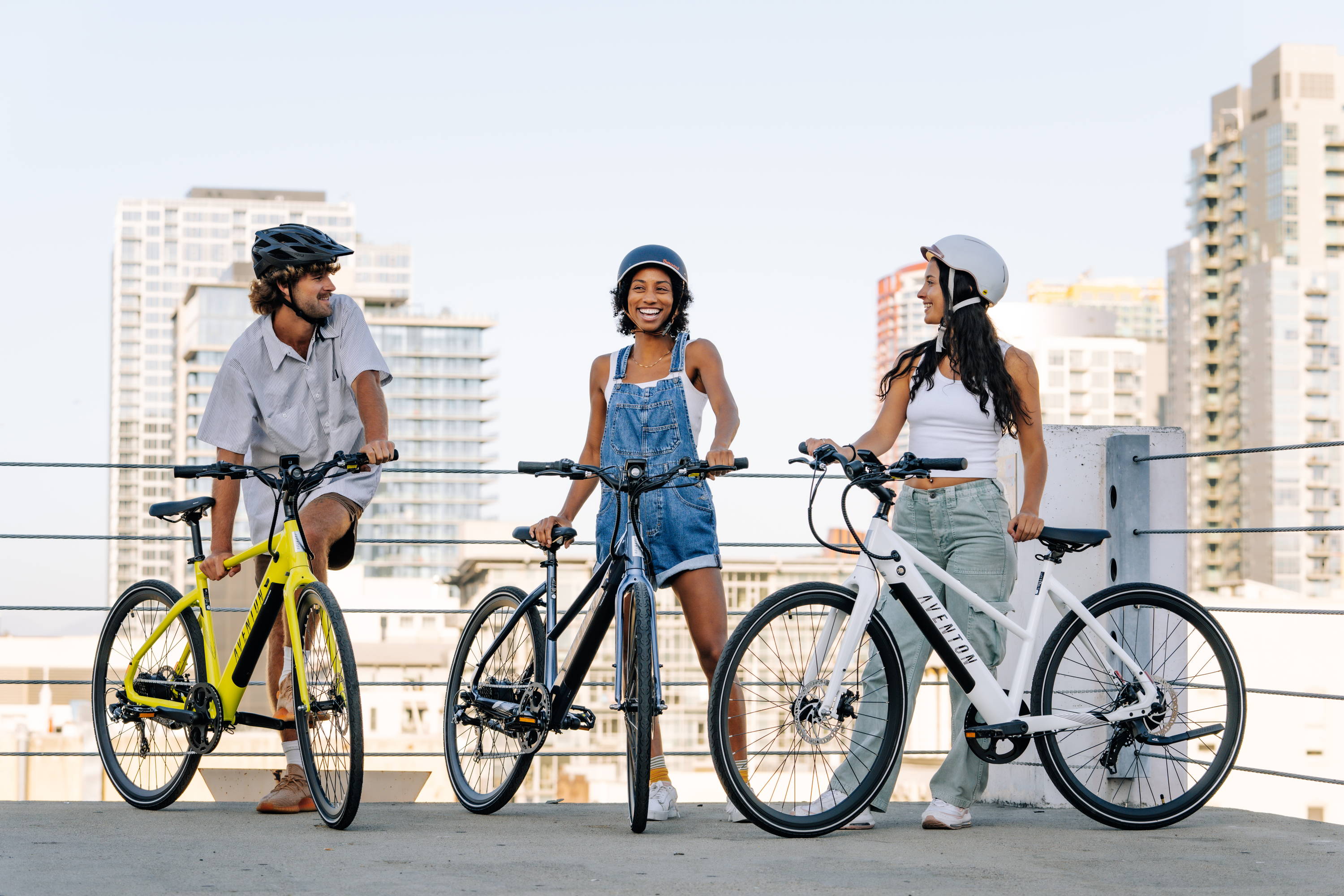 three young people with three aventon electric bikes