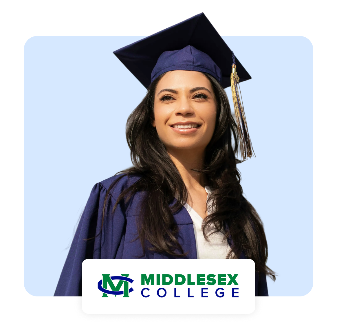 Graduate in cap and gown, smiling against a light blue background.