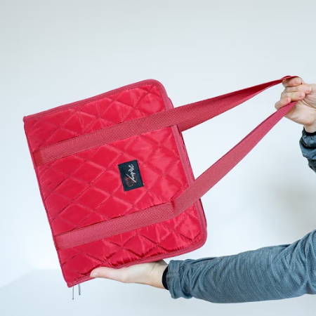 women holding a red zipper binder bag on a white background