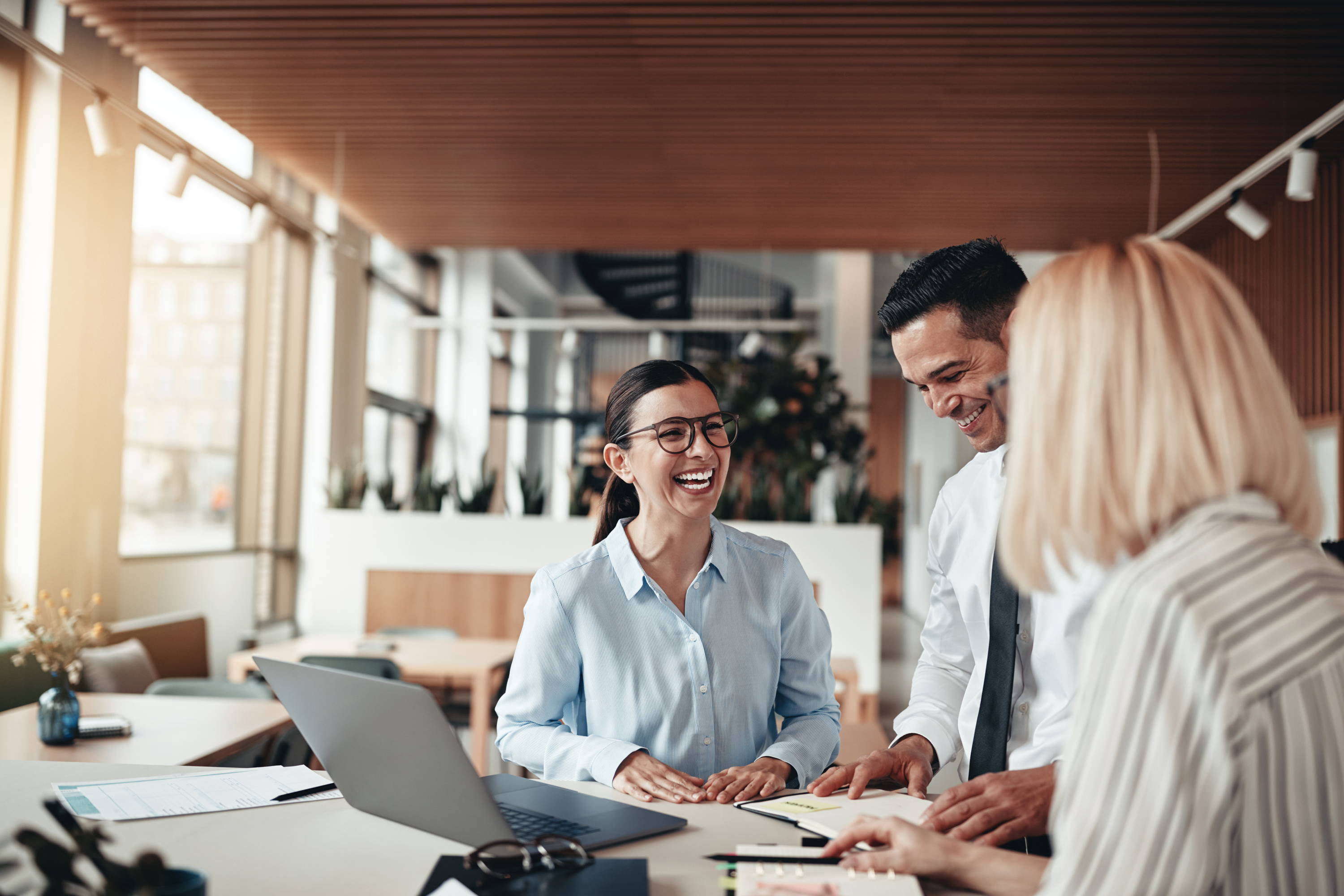 Office coworkers collaborating and laughing together