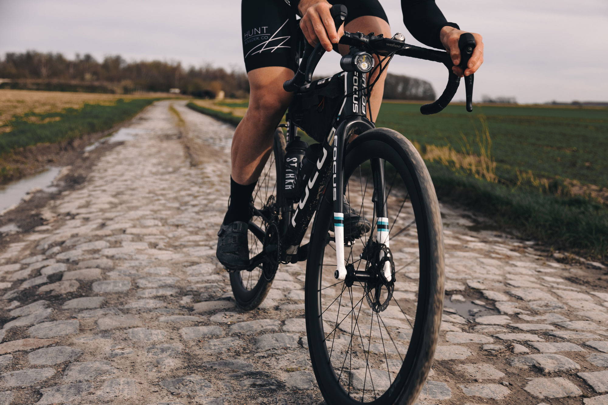 Cyclist riding cobbles on the HUNT 40 Carbon Disc wheels