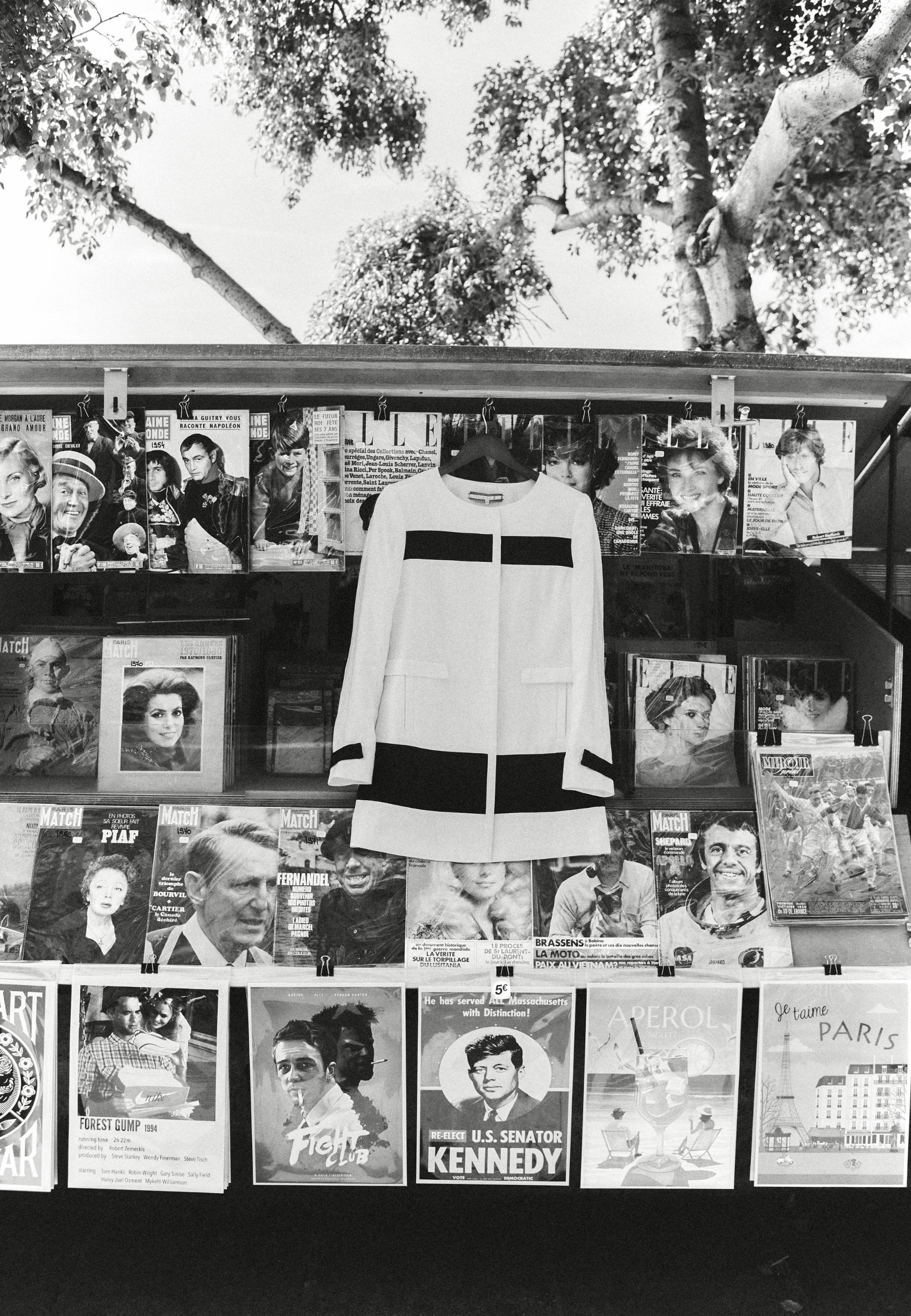 A display of magazines and a black and white jacket.