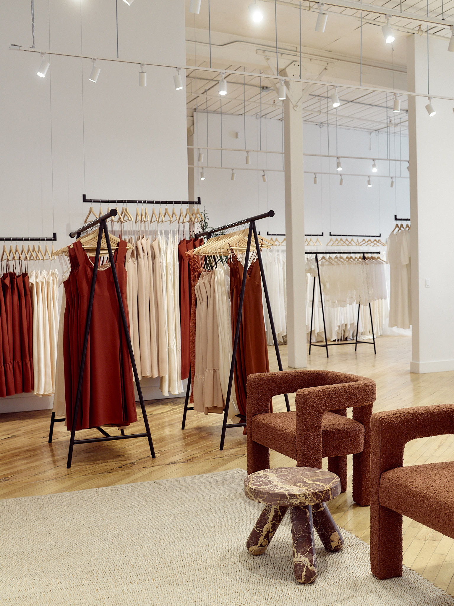 Park & Fifth's Toronto Studio interior with racks of dresses and modern furniture.