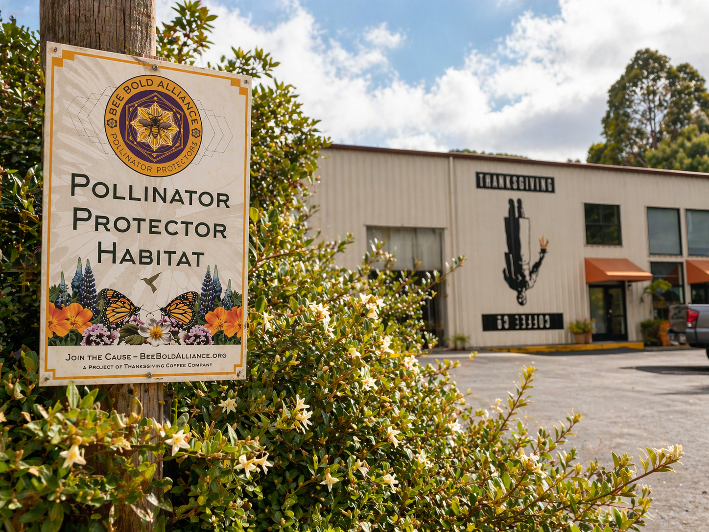 Sign for Pollinator Protector Habitat in front of a building.