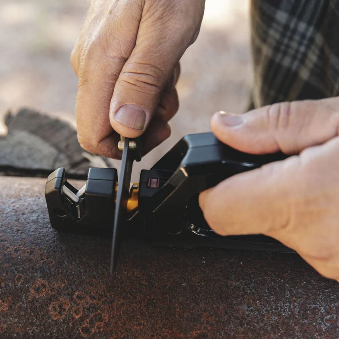 Person using a tool to measure or cut a metal pipe.