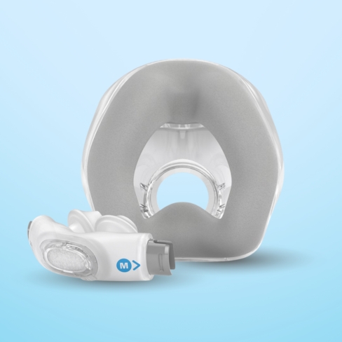 A white medical mask and headgear against a light blue background.