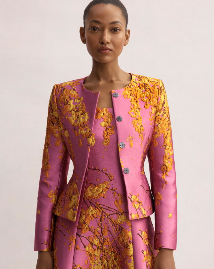 Model wearing pink multicolour jacquard Venetia jacket and Casciano dress