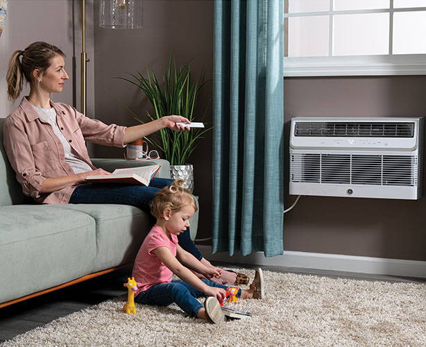 mom and daughter sitting comfortably in room with built-in air conditioner