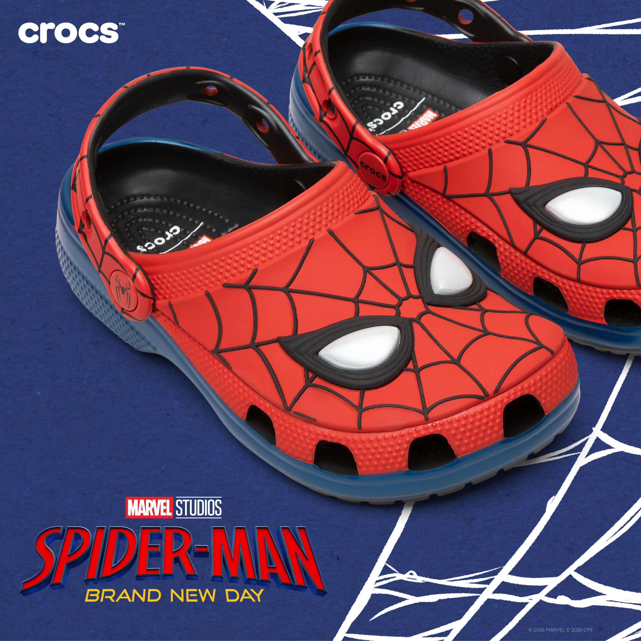 Red Spider-Man themed Crocs shoes on a blue background.