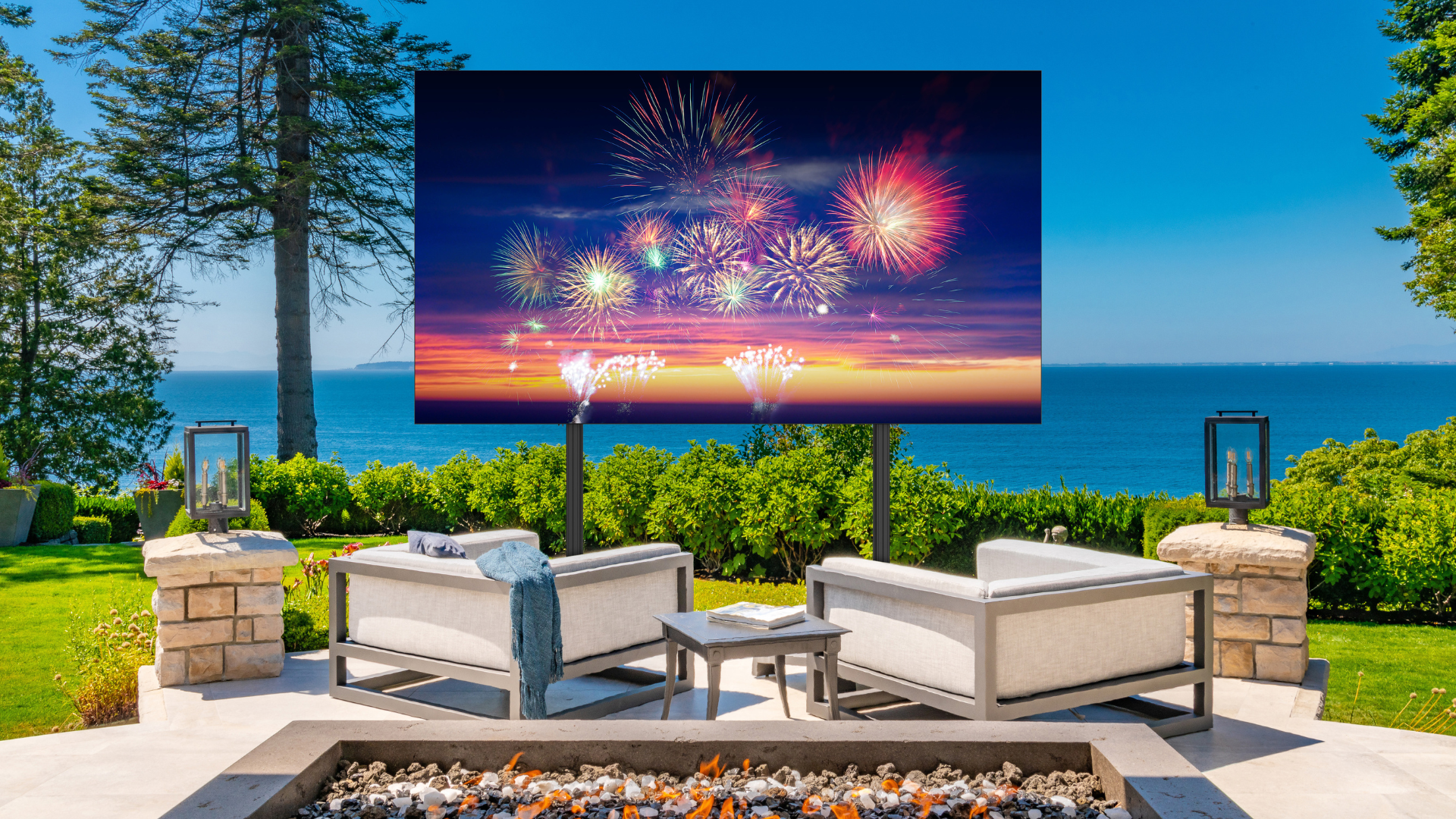 Outdoor seating area with a large dvLED displaying over the ocean.