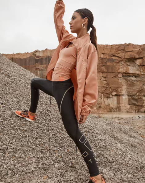 Girl standing in a quarry wearing athleisure