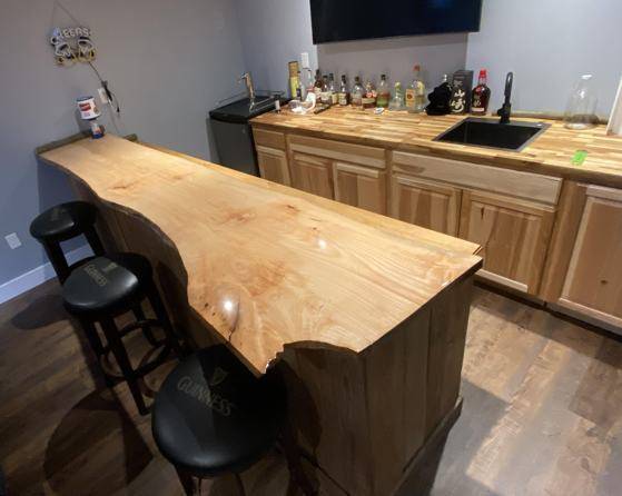 A live-edge wooden epoxy bar top made with UltraClear Epoxy.