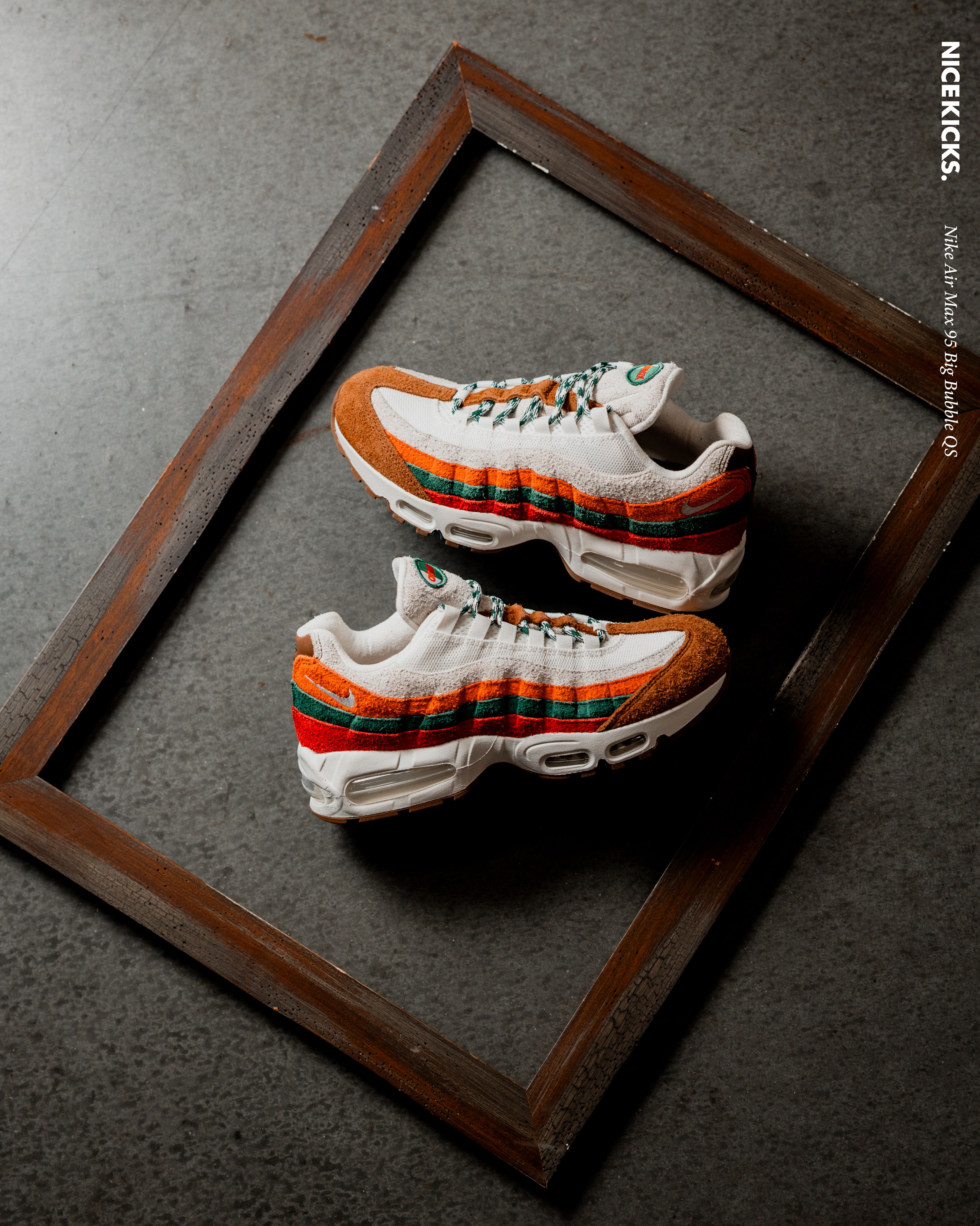 A pair of colorful sneakers displayed in a wooden frame.