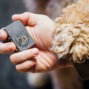 Paw Pump Design lighter in hand with a dogs paw 