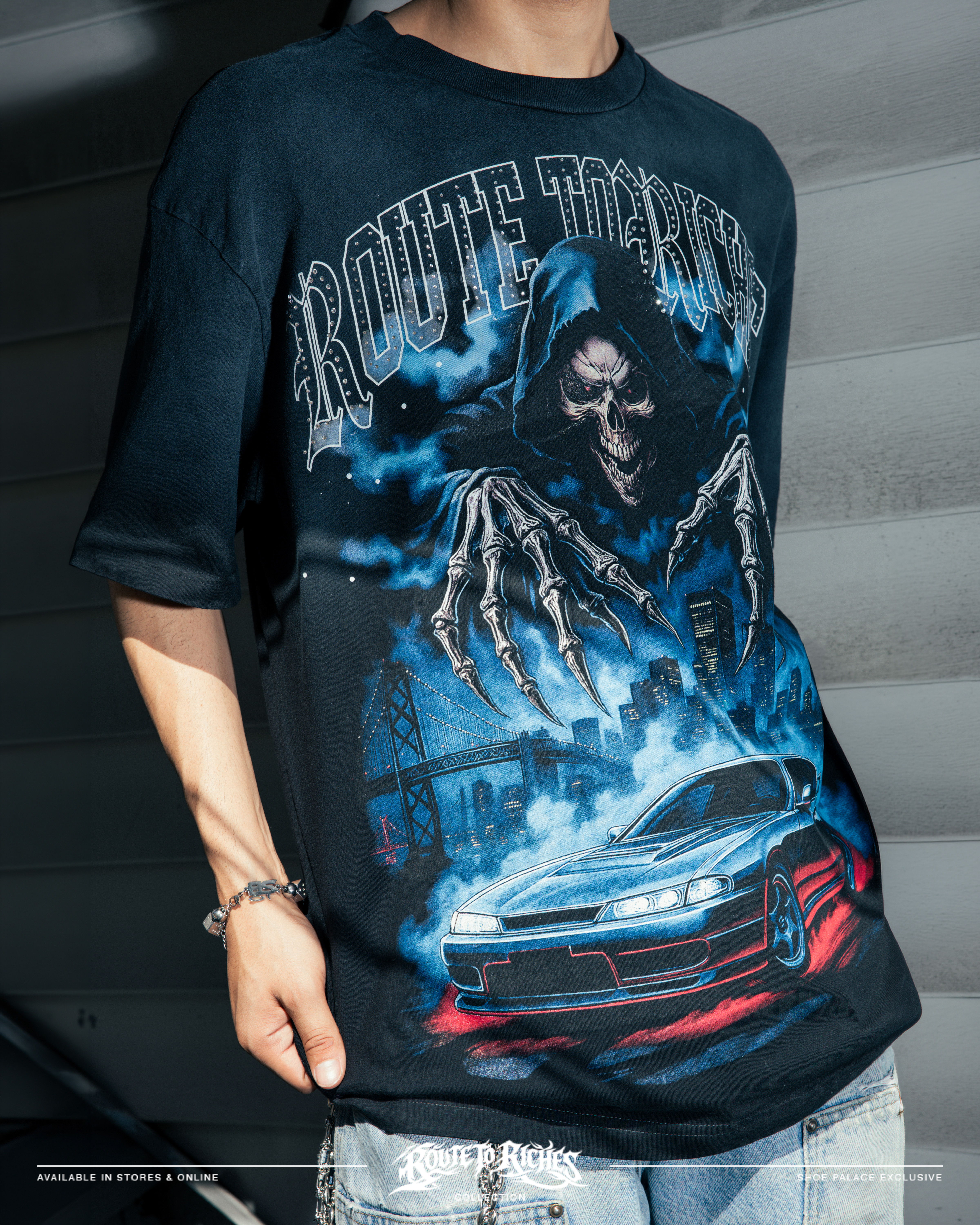Person wearing a graphic t-shirt featuring a car and a grim reaper design.