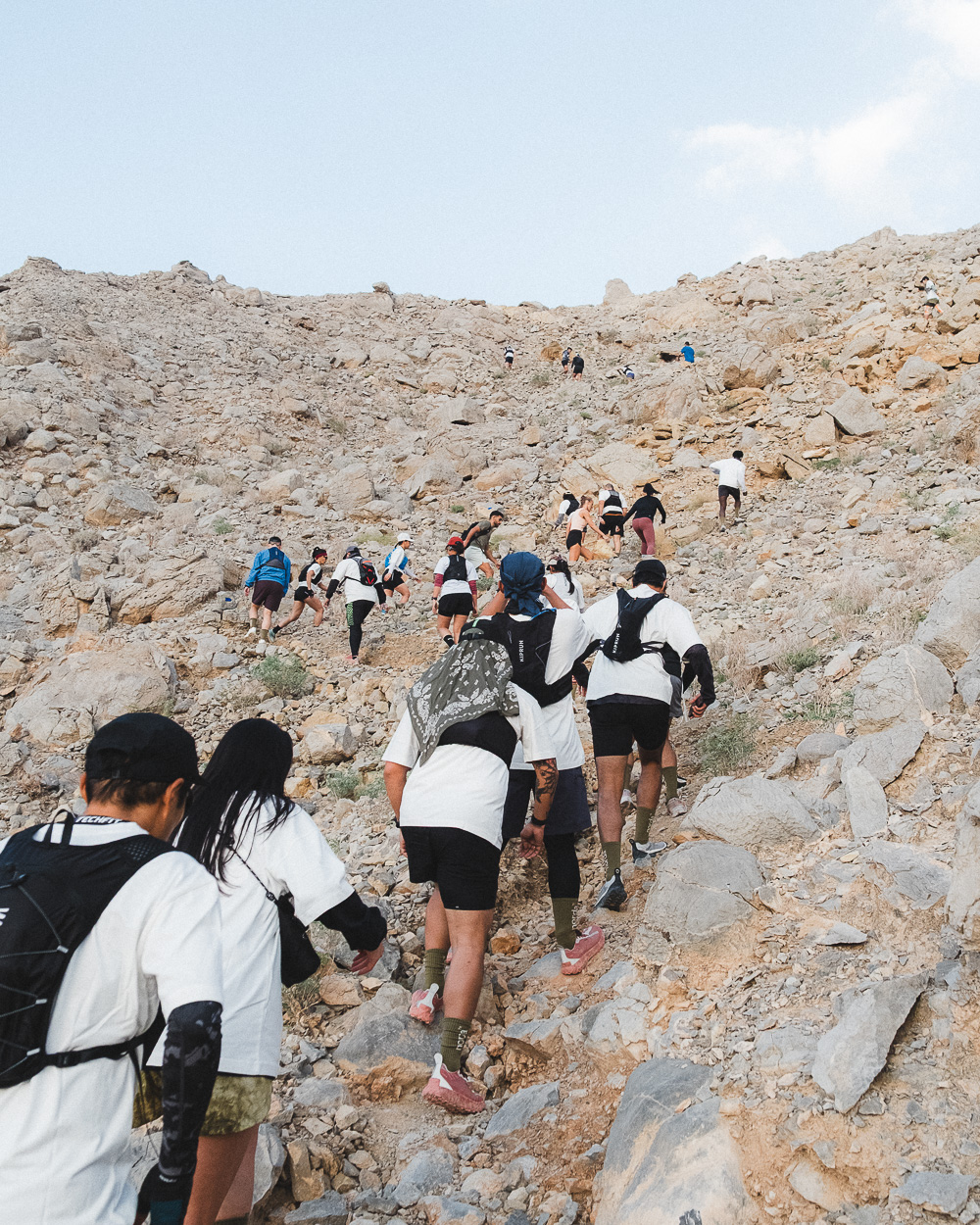 Trail runners climbing through Rainbow Valley