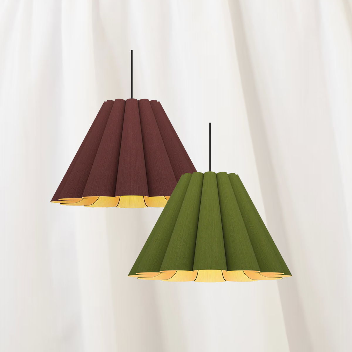 Two pendant lamps in maroon and green hanging against a white background.