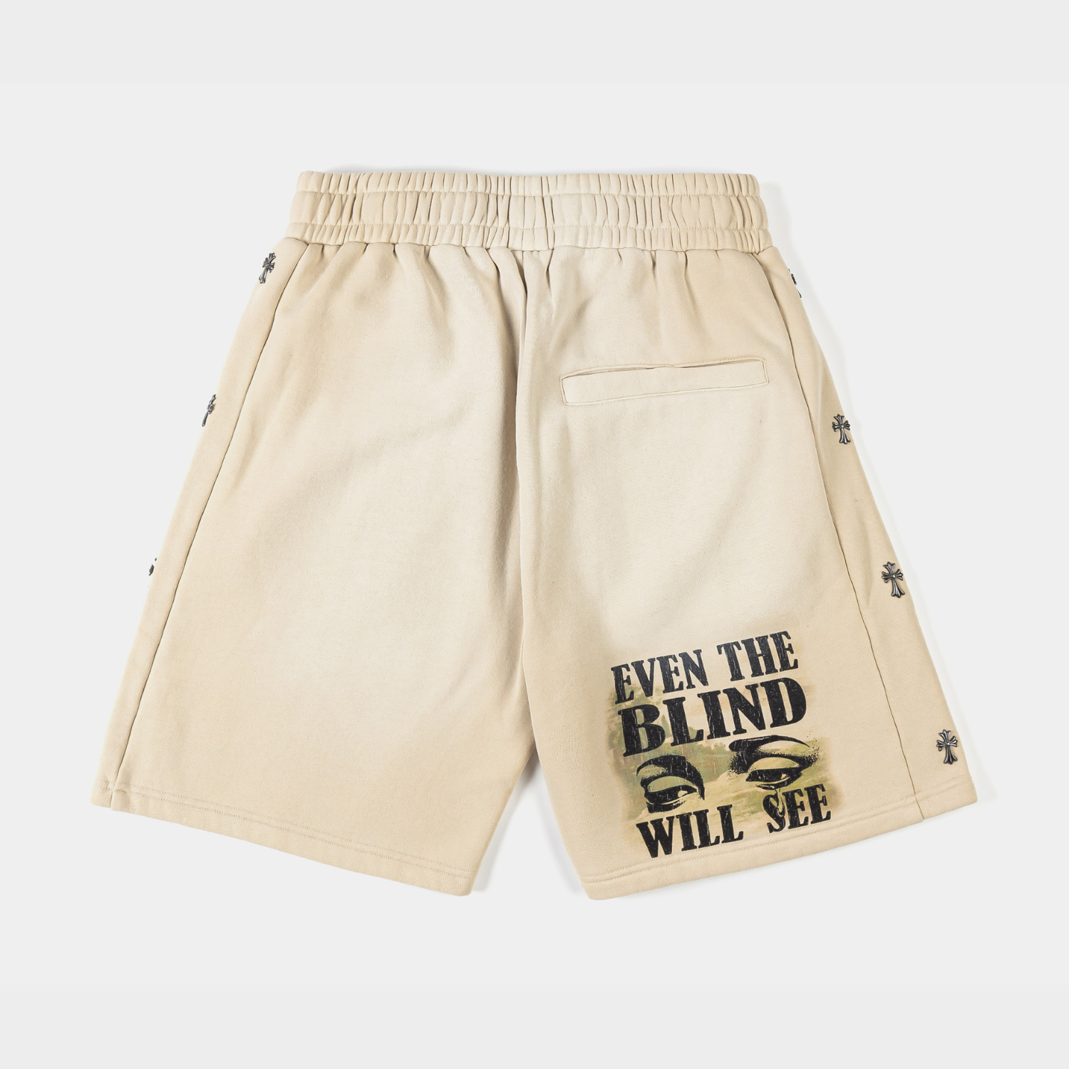 Beige shorts with a colorful graphic and embroidered design.
