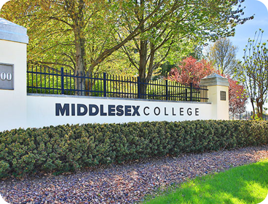 Sign for Middlesex College with landscaped surroundings.