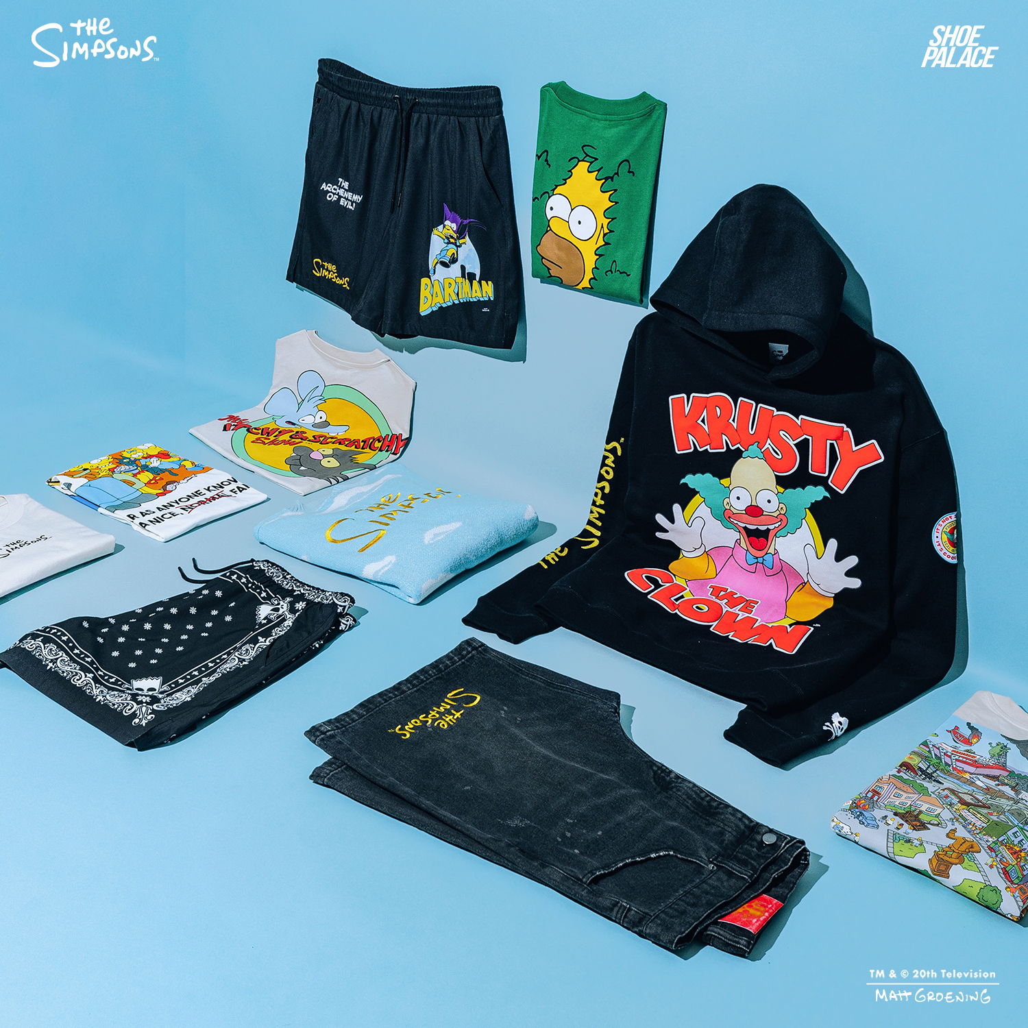 Clothing and merchandise featuring characters from The Simpsons, displayed on a blue background.