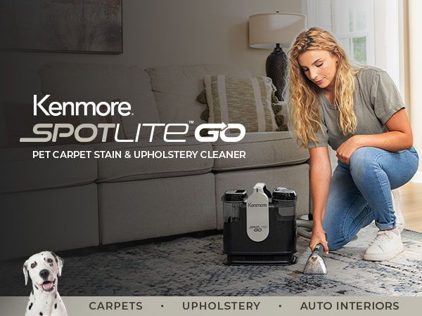 A woman cleans a rug with the Spotlite GO