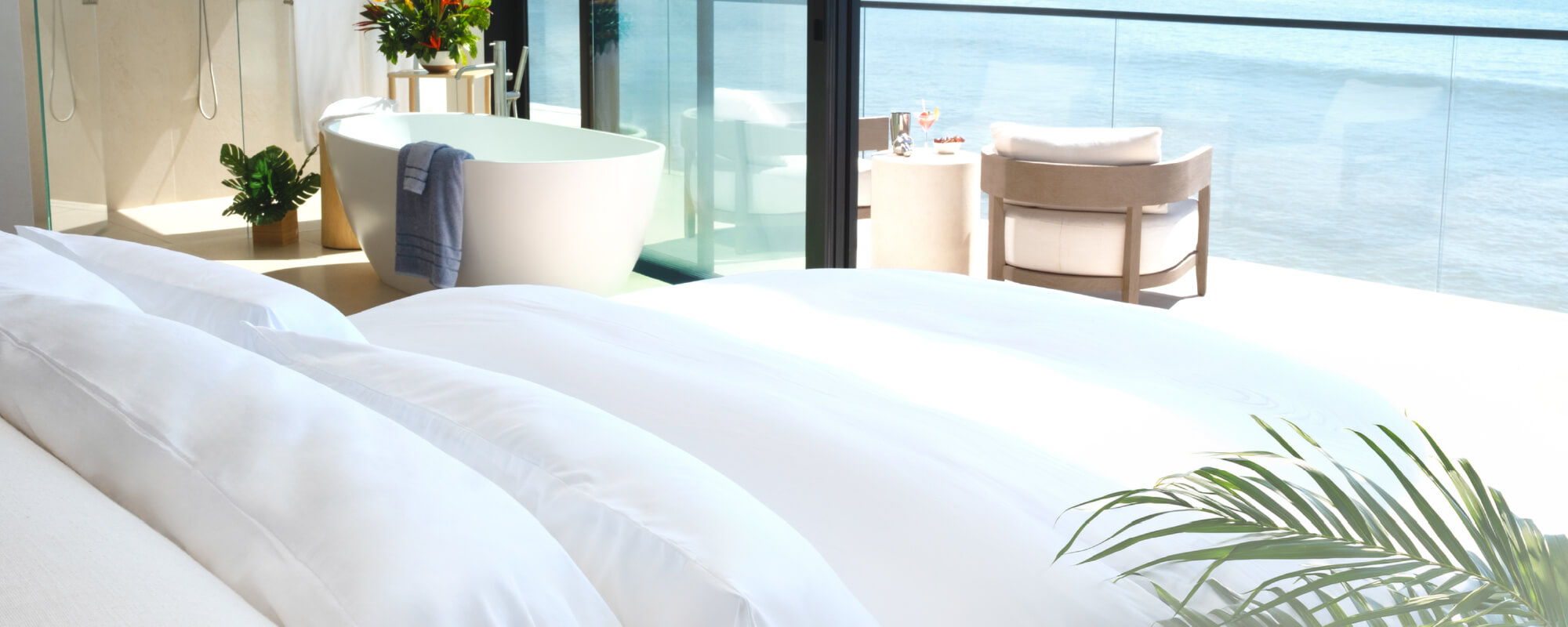 a bed in a modern beachfront bedroom