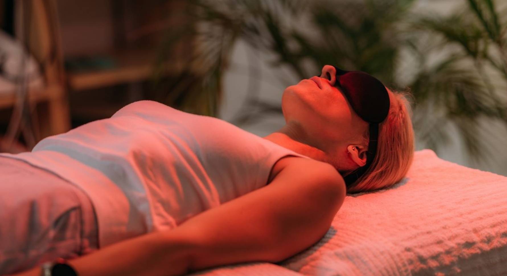 Lady using red light therapy for skin tightening treatments