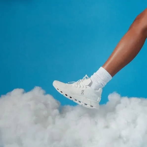 white on cloudnova shoes on foot in the sky