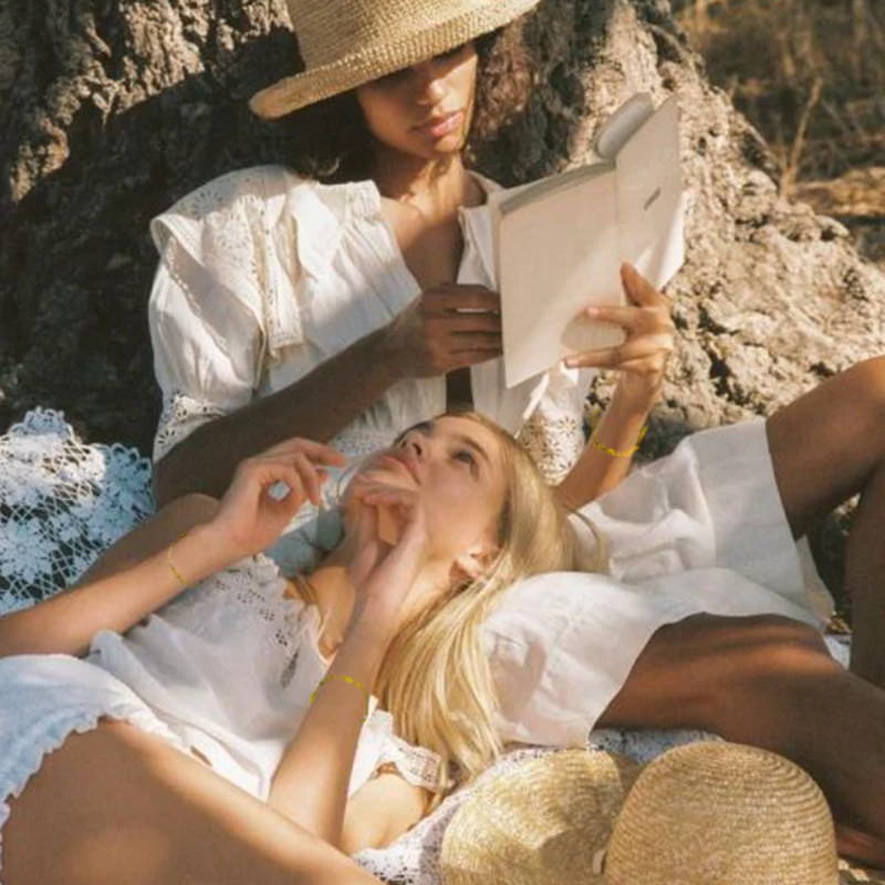 two women laying in nature with divination tools