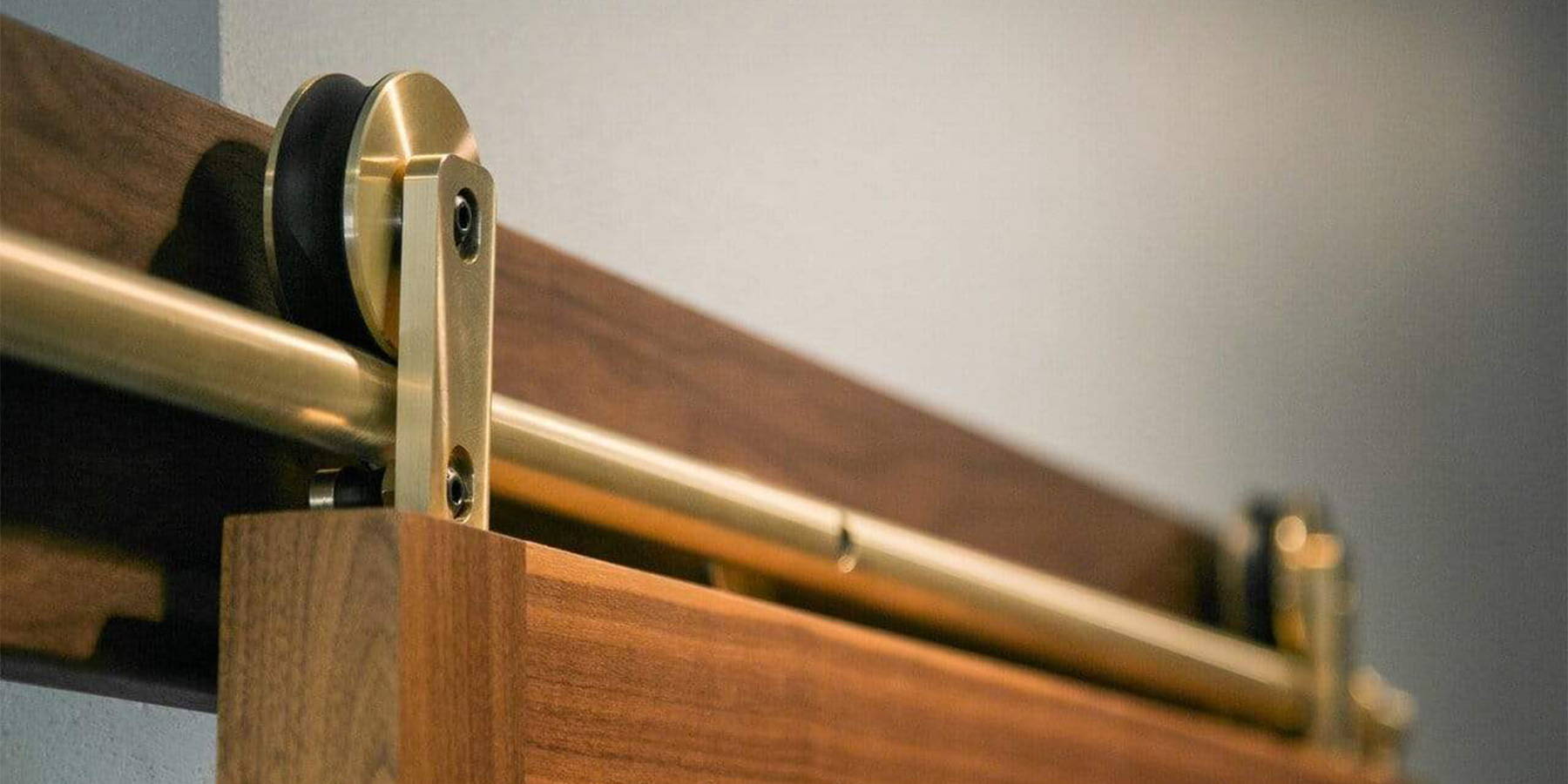 Solid Brass Swiss Rod hardware installed on a sapele mahogany door