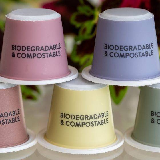 Colorful cups stacked on each other with biodegradable and compostable text on packaging